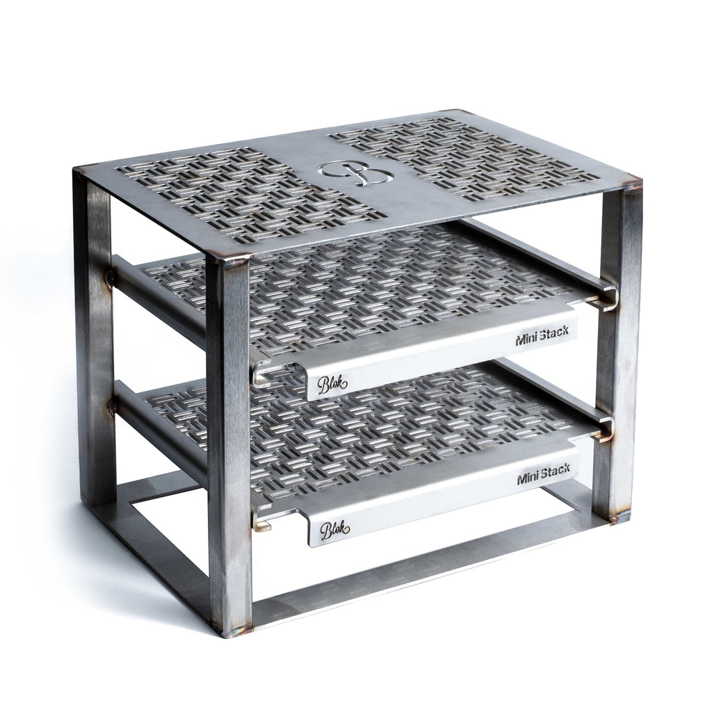 metal grill stand with engraved patterns on a white background