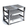 metal grill stand with engraved patterns on a white background
