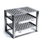 metal grill stand with engraved patterns on a white background